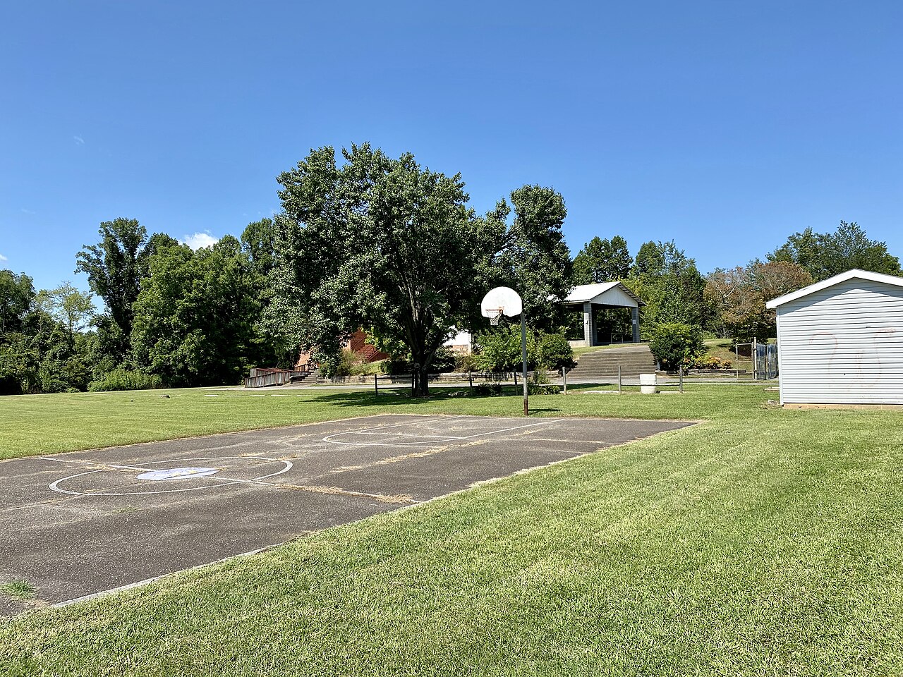 A quiet school campus lawn and outdoor court